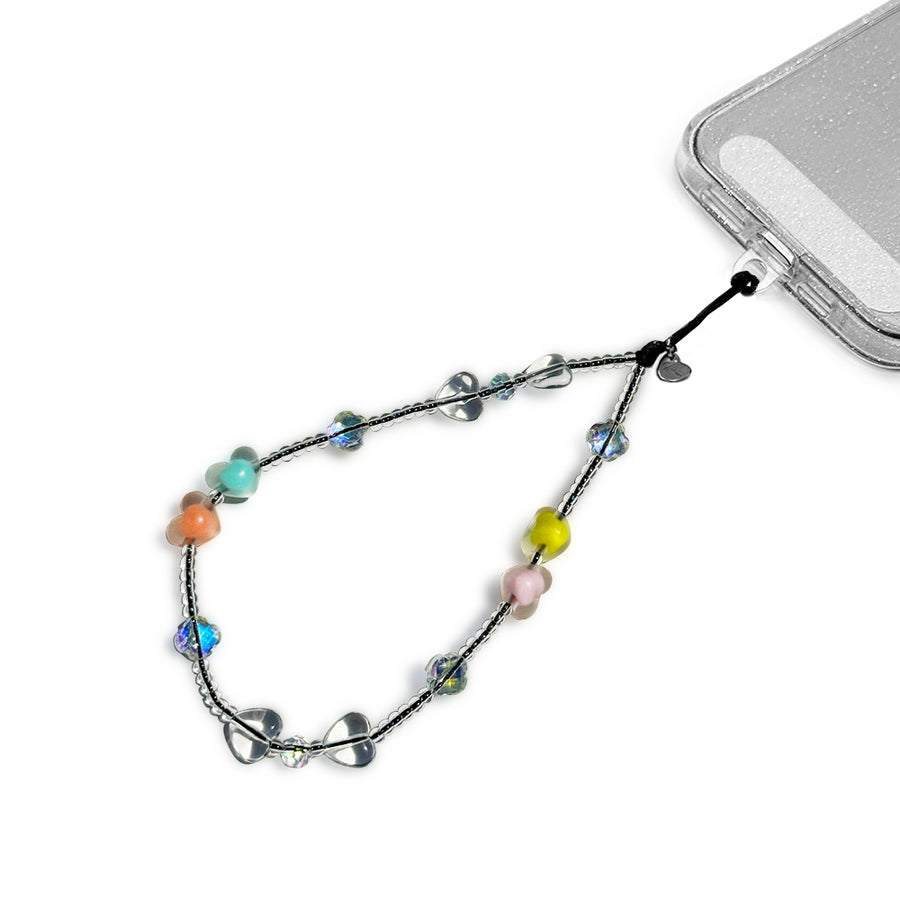 Candy Hatossa Phone charm attached to a phone with a universal lanyard holder. 