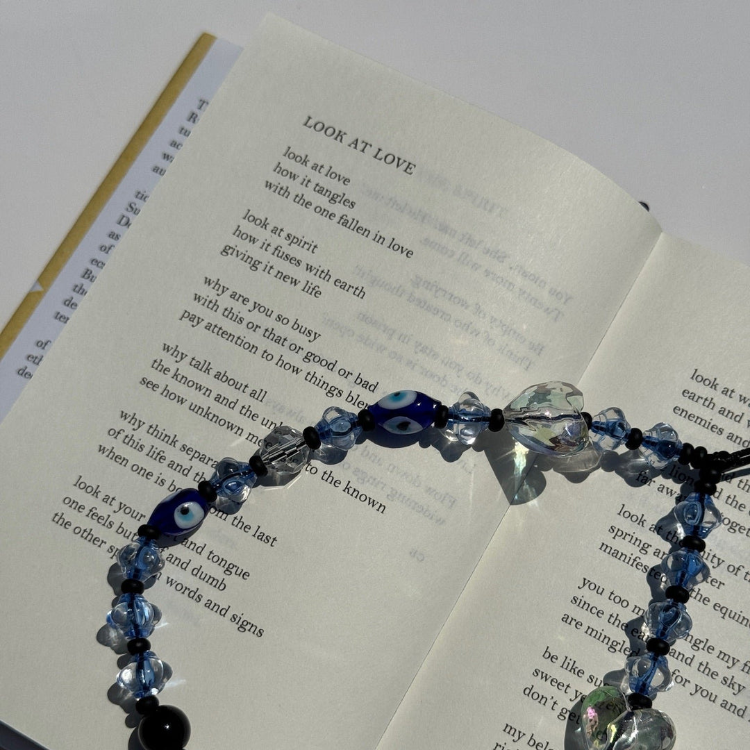 Image shows the Hatossa Caspian phone strap, phone charm, with the universal lanyard holder that can be used with any device, ebook, airpods
