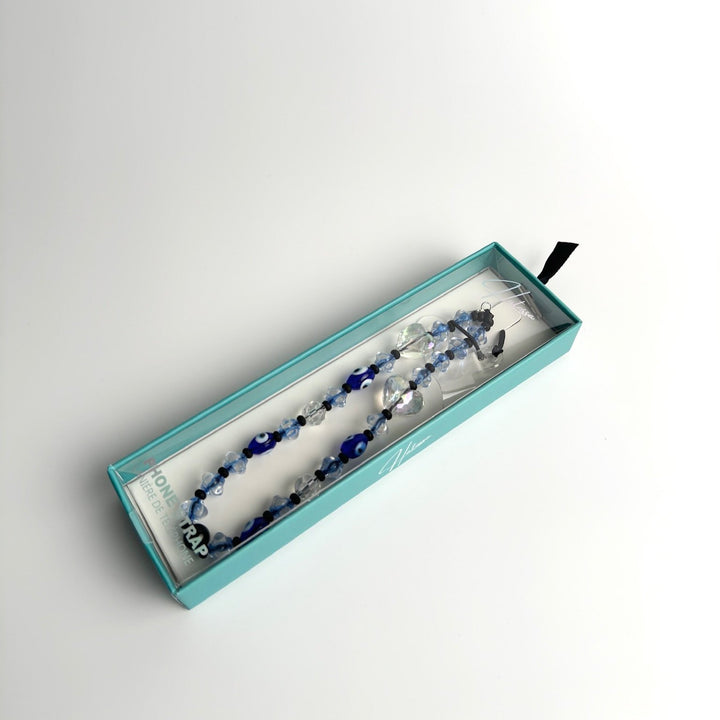 Image shows a packaged Hatossa Caspian phone strap, phone charm, with the universal lanyard holder that can be used with any device, ebook, airpods