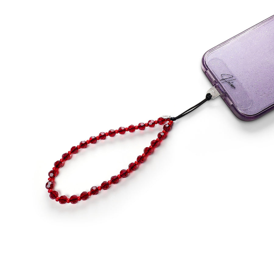Cherry Hatossa Phone charm attached to a phone with a universal lanyard holder.