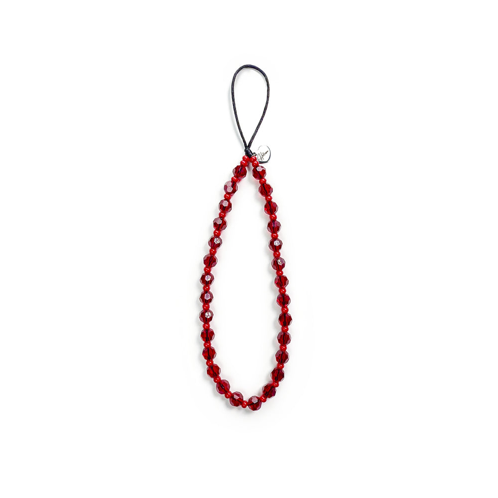 Cherry Hatossa Phone charm placed against a white background, not attached to anything. The charm has red beads.