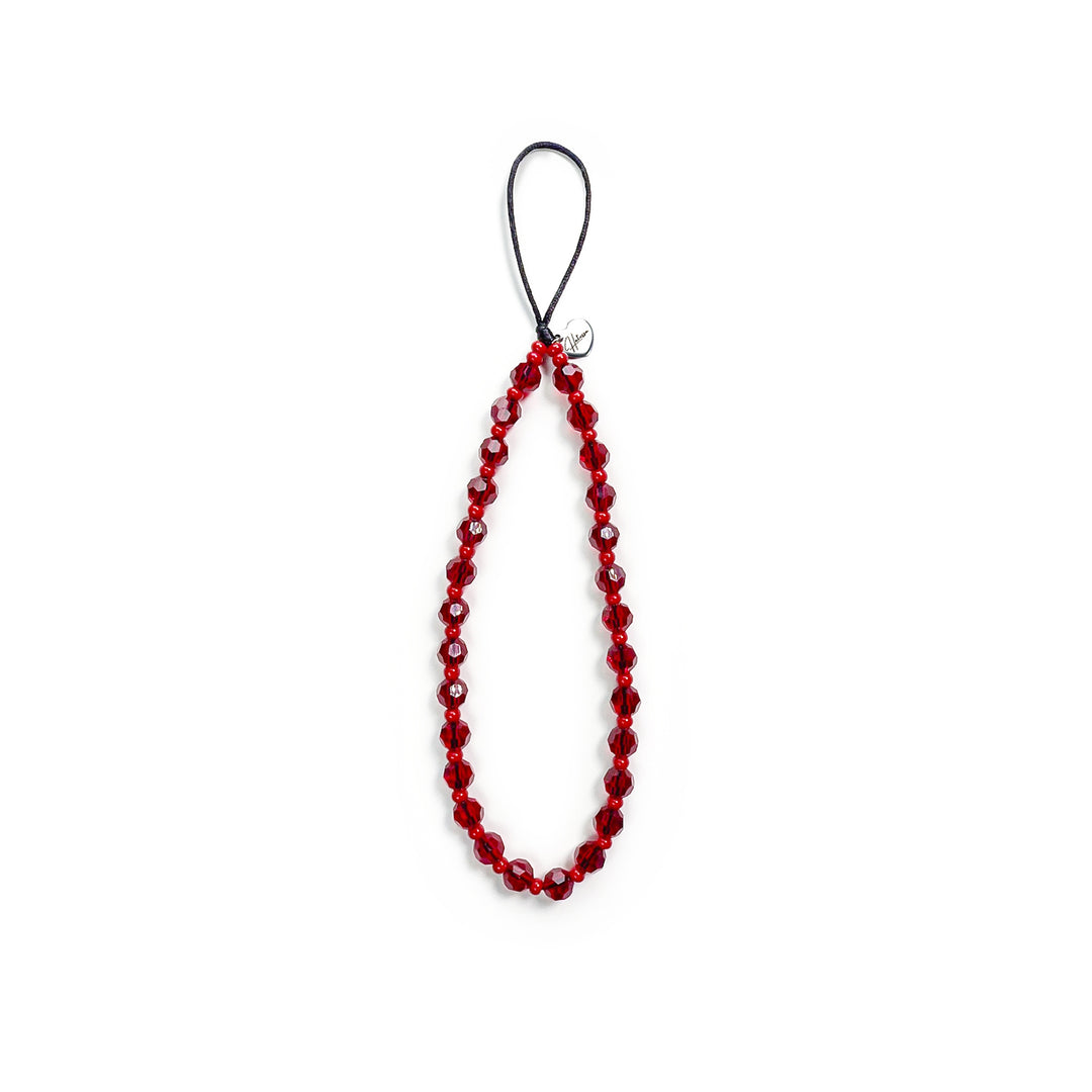Cherry Hatossa Phone charm placed against a white background, not attached to anything. The charm has red beads.