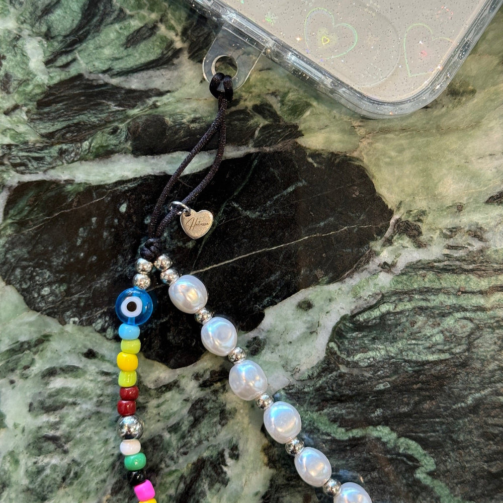 Image shows the Hatossa GEMINI phone strap, phone charm, with the universal lanyard holder that can be used with any device, ebook, airpods