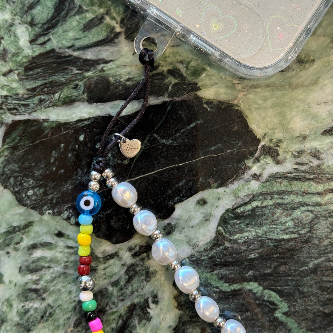 Image shows the Hatossa GEMINI phone strap, phone charm, with the universal lanyard holder that can be used with any device, ebook, airpods