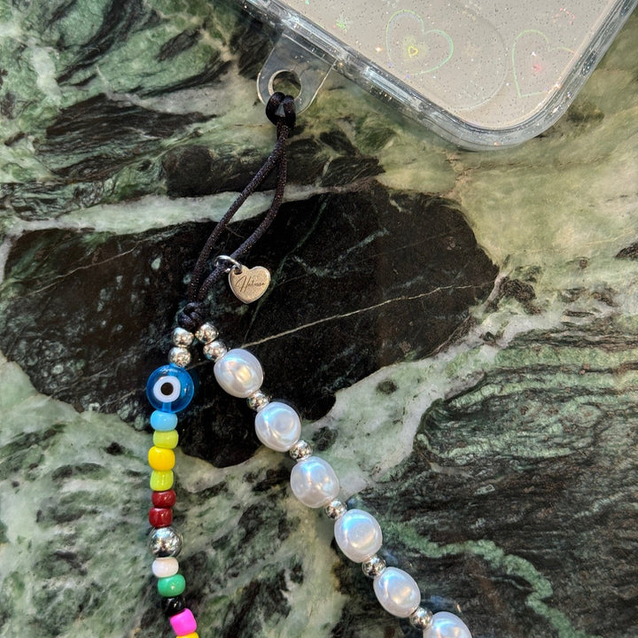 Image shows the Hatossa GEMINI phone strap, phone charm, with the universal lanyard holder that can be used with any device, ebook, airpods