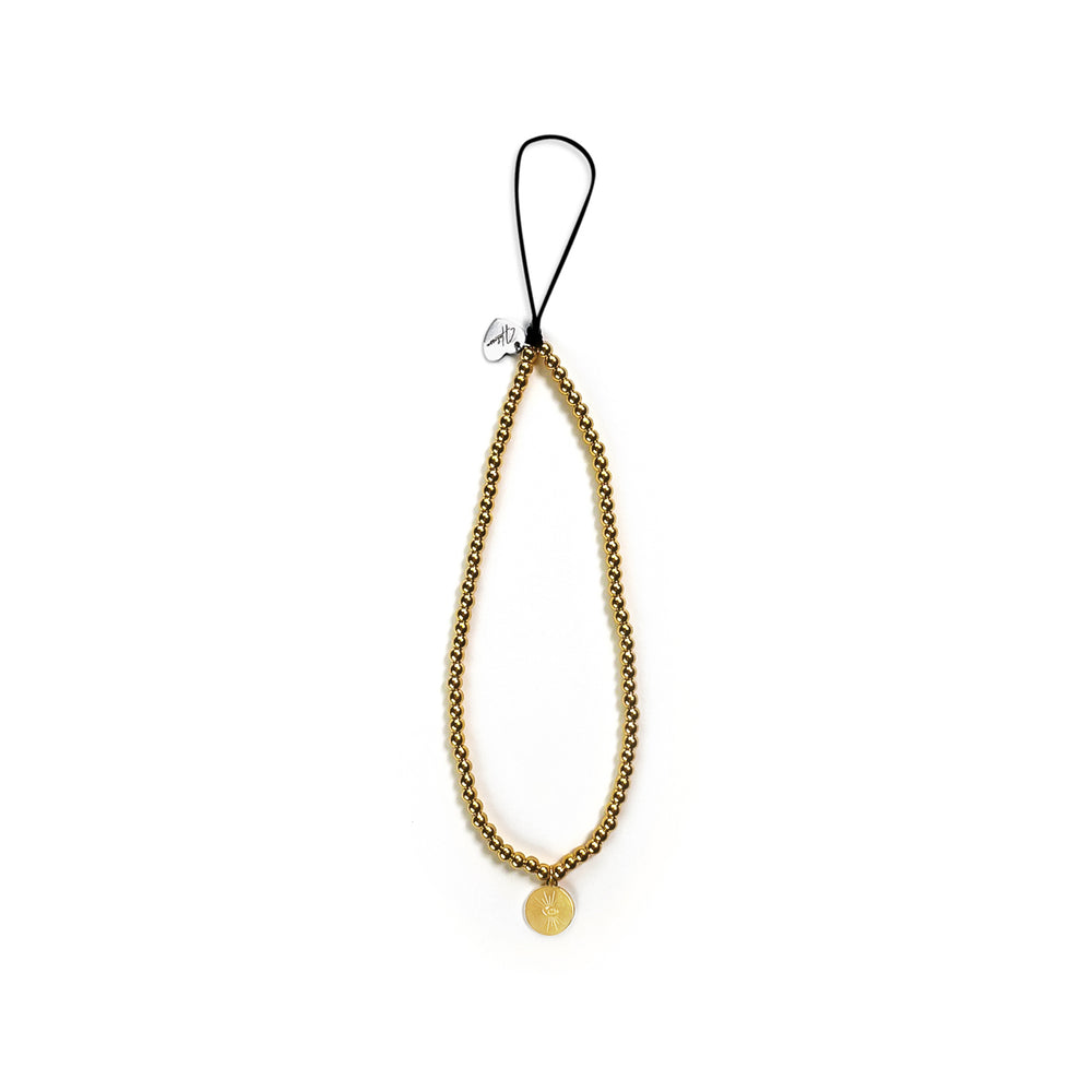 Golden Hatossa Phone charm placed flat against a white background. The charm is gold, tarnish free and as a sun-shaped pendant. 