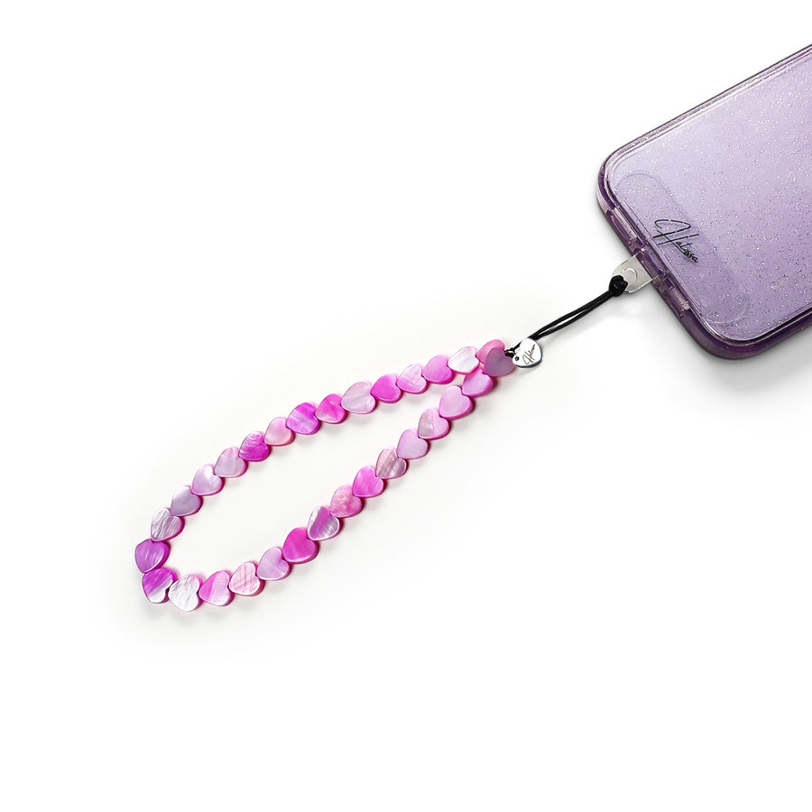 Hearty Hatossa Phone charm made of real seashells attached to a phone with the universal lanyard holder. 