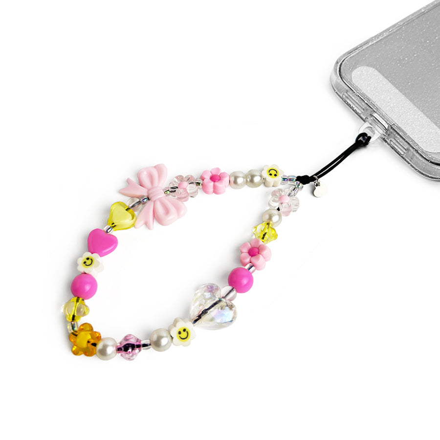 Honey Hatossa Phone charm attached to a phone with a universal lanyard holder. 