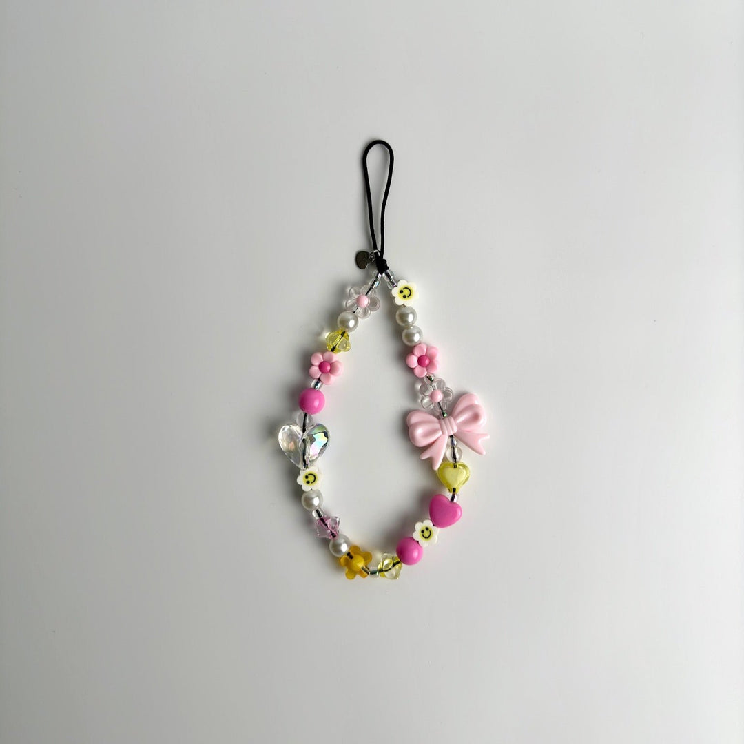 Image shows the Hatossa HONEY phone strap, phone charm, with the universal lanyard holder that can be used with any device, ebook, airpods