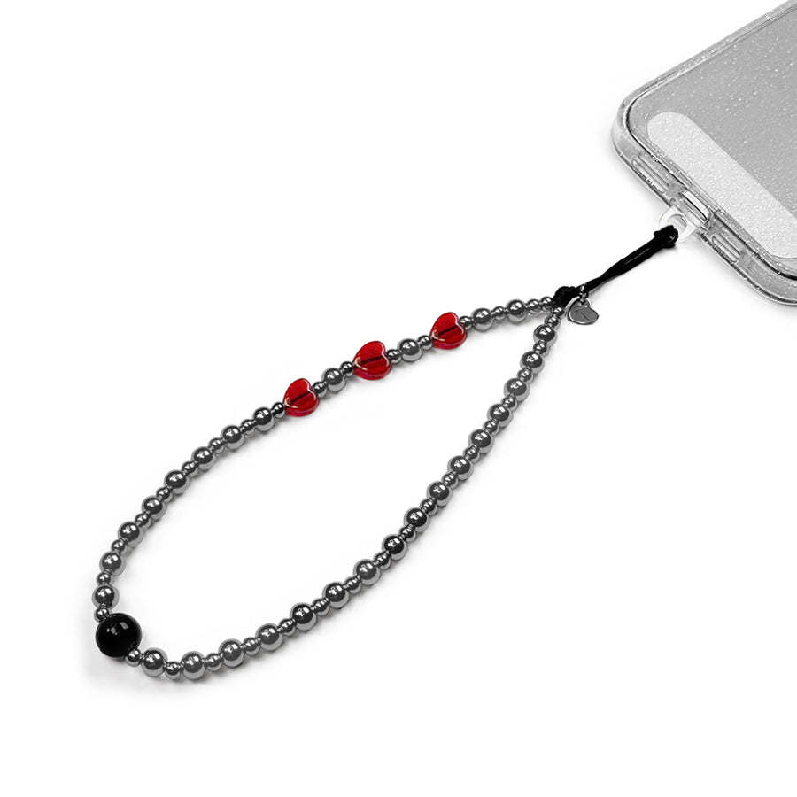 Nova Hatossa Phone charm attached to a phone with a universal lanyard holder. 
