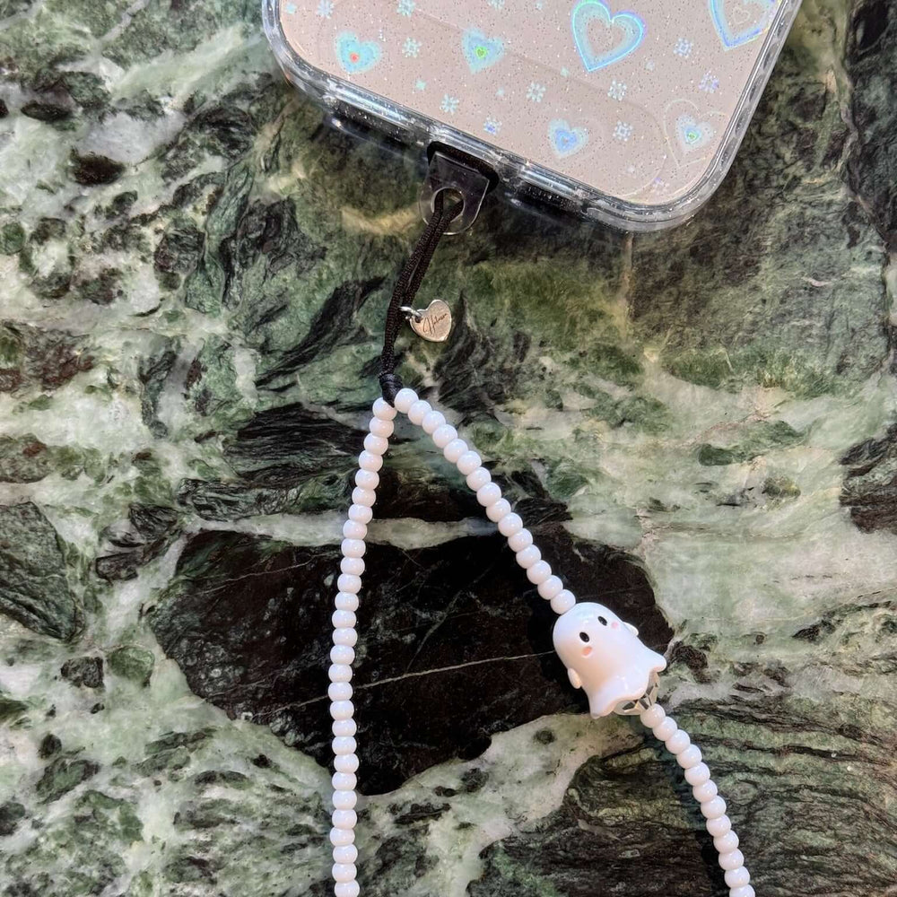 Image shows the Hatossa Spooky phone strap, phone charm, with the universal lanyard holder that can be used with any device, ebook, airpods
