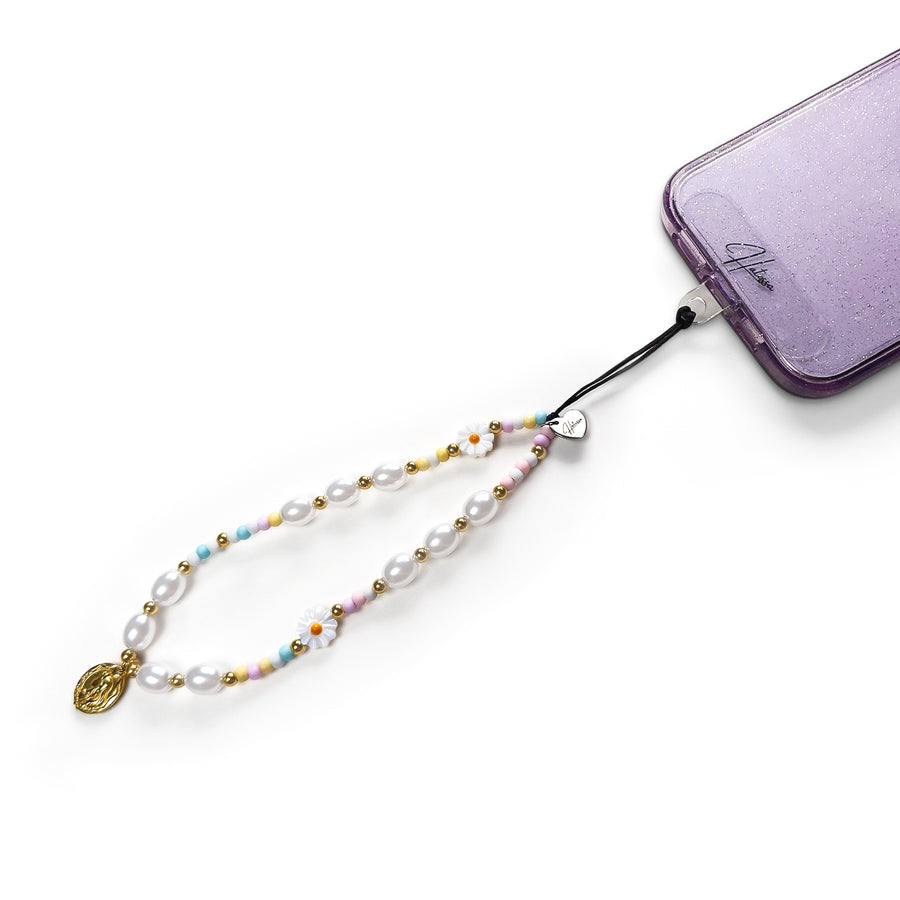 Treasure Hatossa phone charm attached to a phone with the universal lanyard holder.