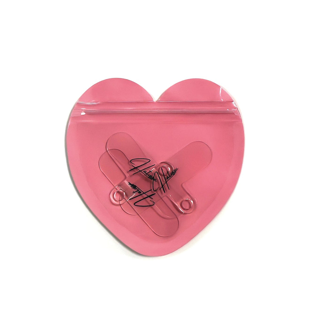 A pack of 3 Hatossa universal lanyard holders that are inside a heart shaped PVC bag.